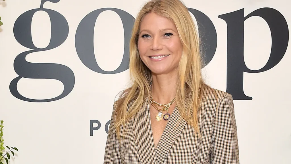 Gwyneth Paltrow in front of GOOP sign.